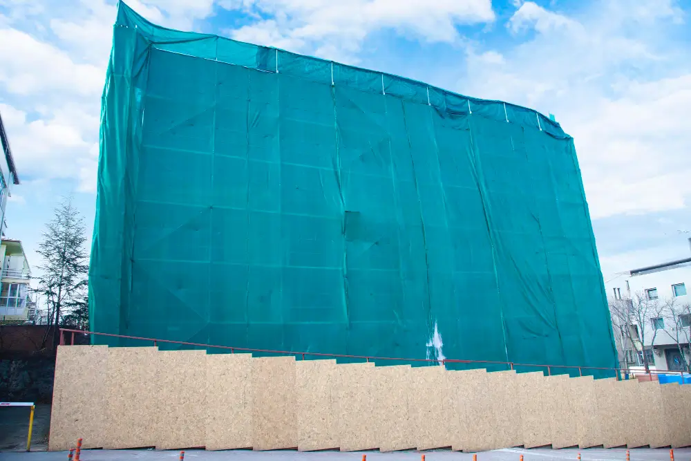 Scaffolding wrapped in clear enclosure tarps